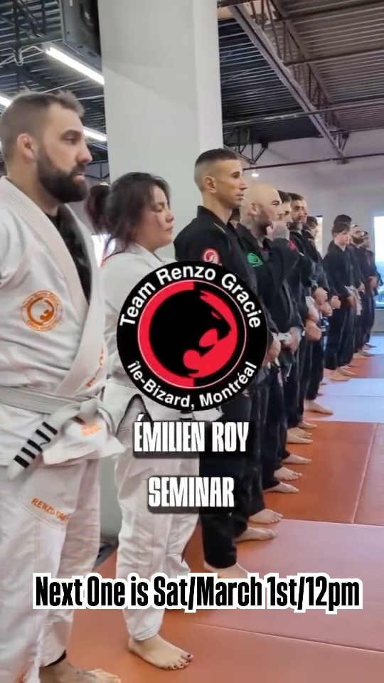 Students in gis line up on orange mats under a seminar title card
