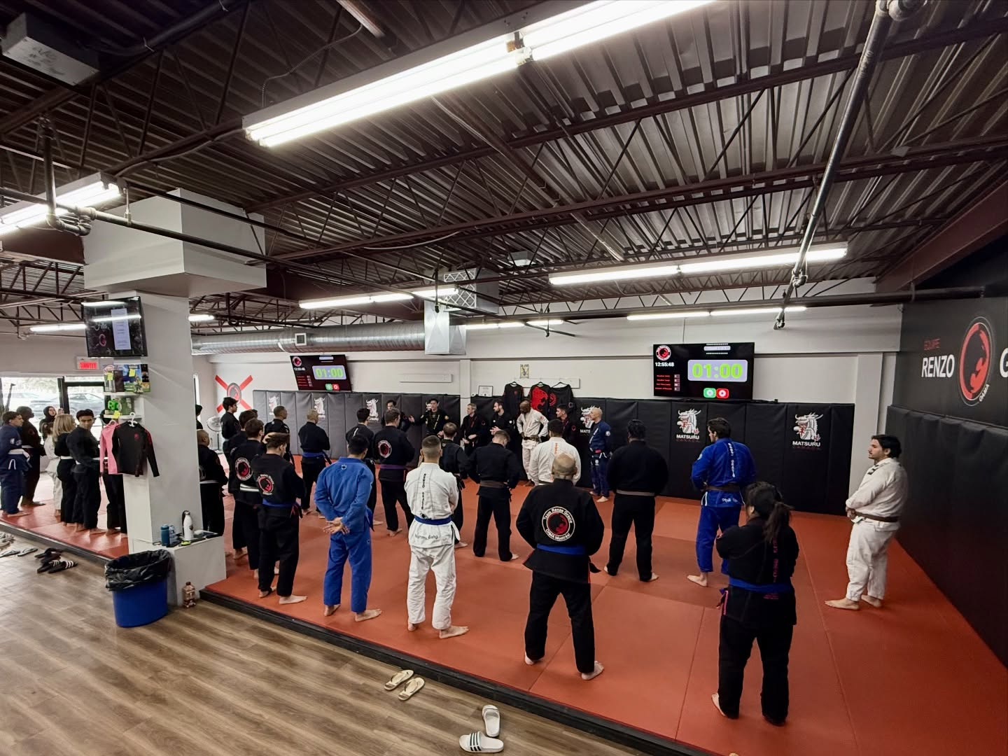 Students in gis line up on the red mats for a class