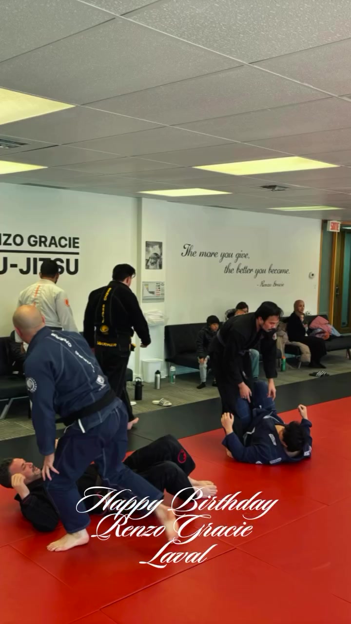 Adults in gis drill on red mats under the Renzo Gracie Jiu-Jitsu sign, with Happy Birthday text